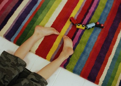 Jonge jongen op een kleurrijk karpet